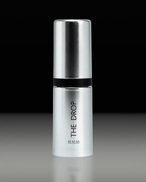 The Lab Drop Ampoule up close on a black and grey background.